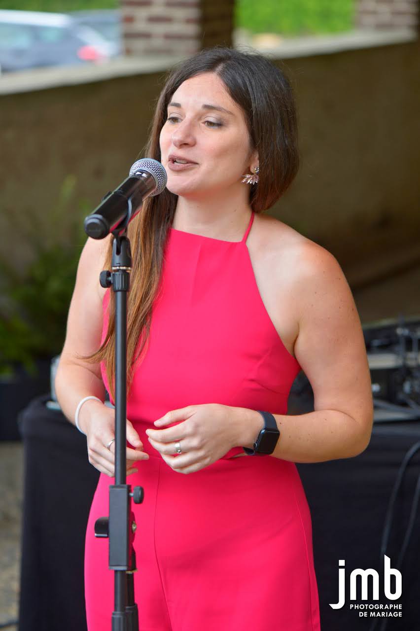 Deb singing at a friend's wedding